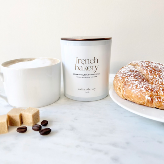 french bakery 7.5oz candle with a coffee and croissant